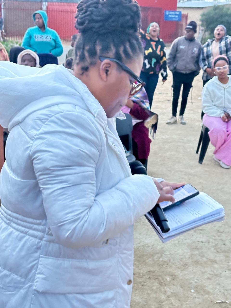 A volunteer taking notes while the gathering sings